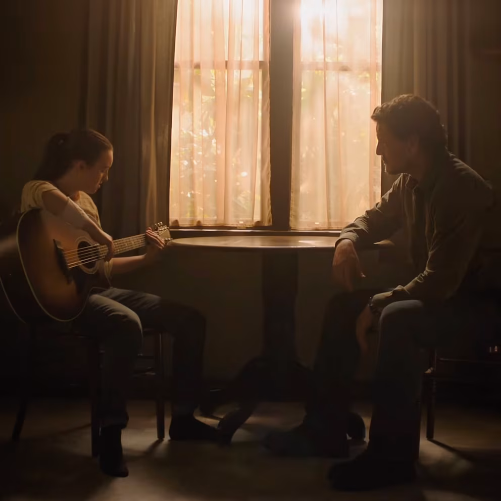 ellie playing guitar for joel